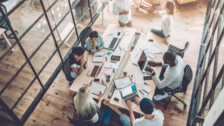 Group of employees working around a table